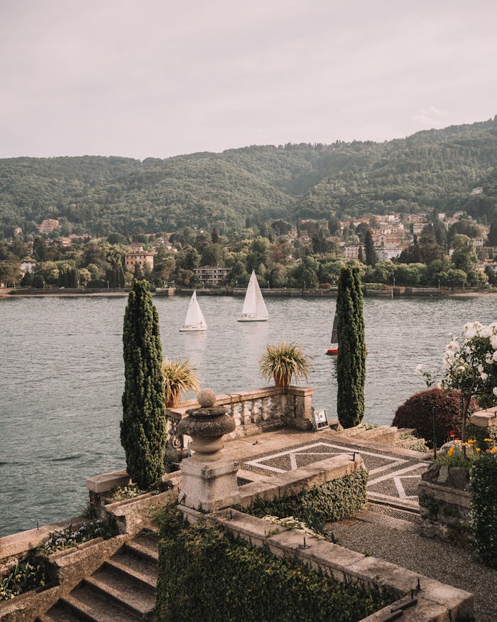 Elegant view over Lake Maggiore with sailboats and Italian gardens in Stresa, Piedmont, Italy.